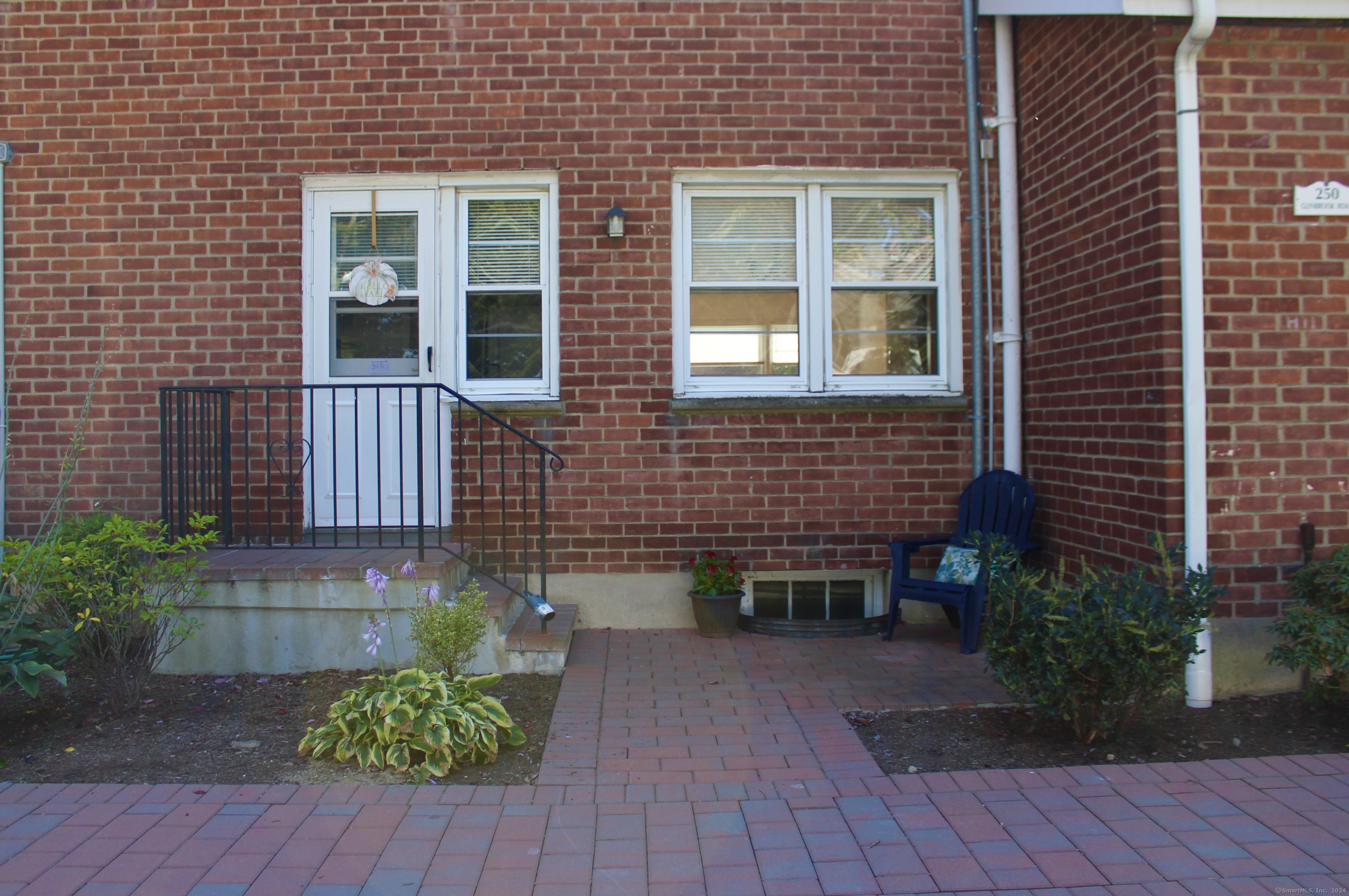 a front view of a house with a yard and outdoor seating