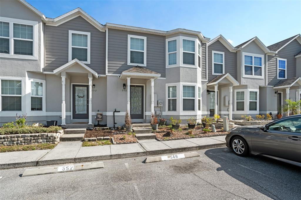 a front view of a building with parked cars