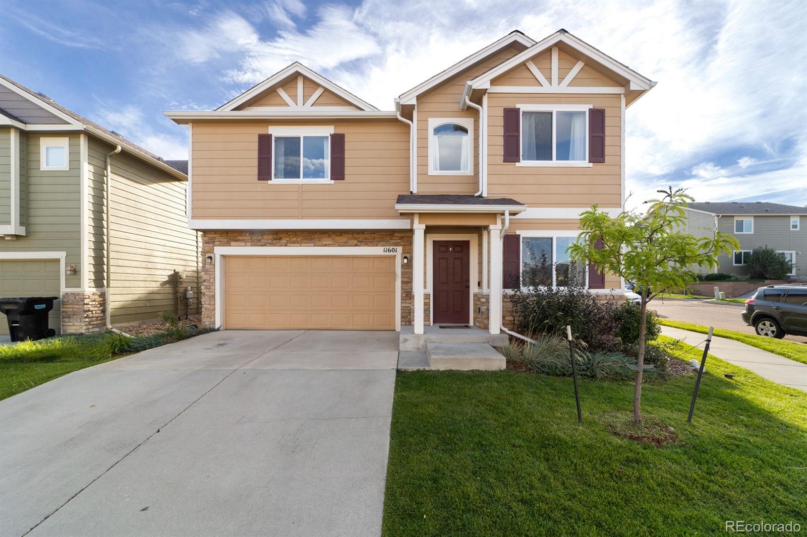 a front view of a house with a yard and garage