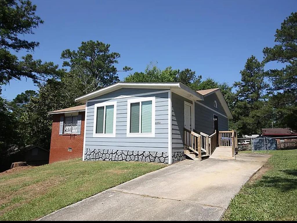 a front view of a house with a garden