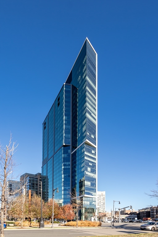 a view of a tall building next to a road