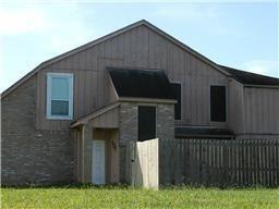 a brick house with a small yard