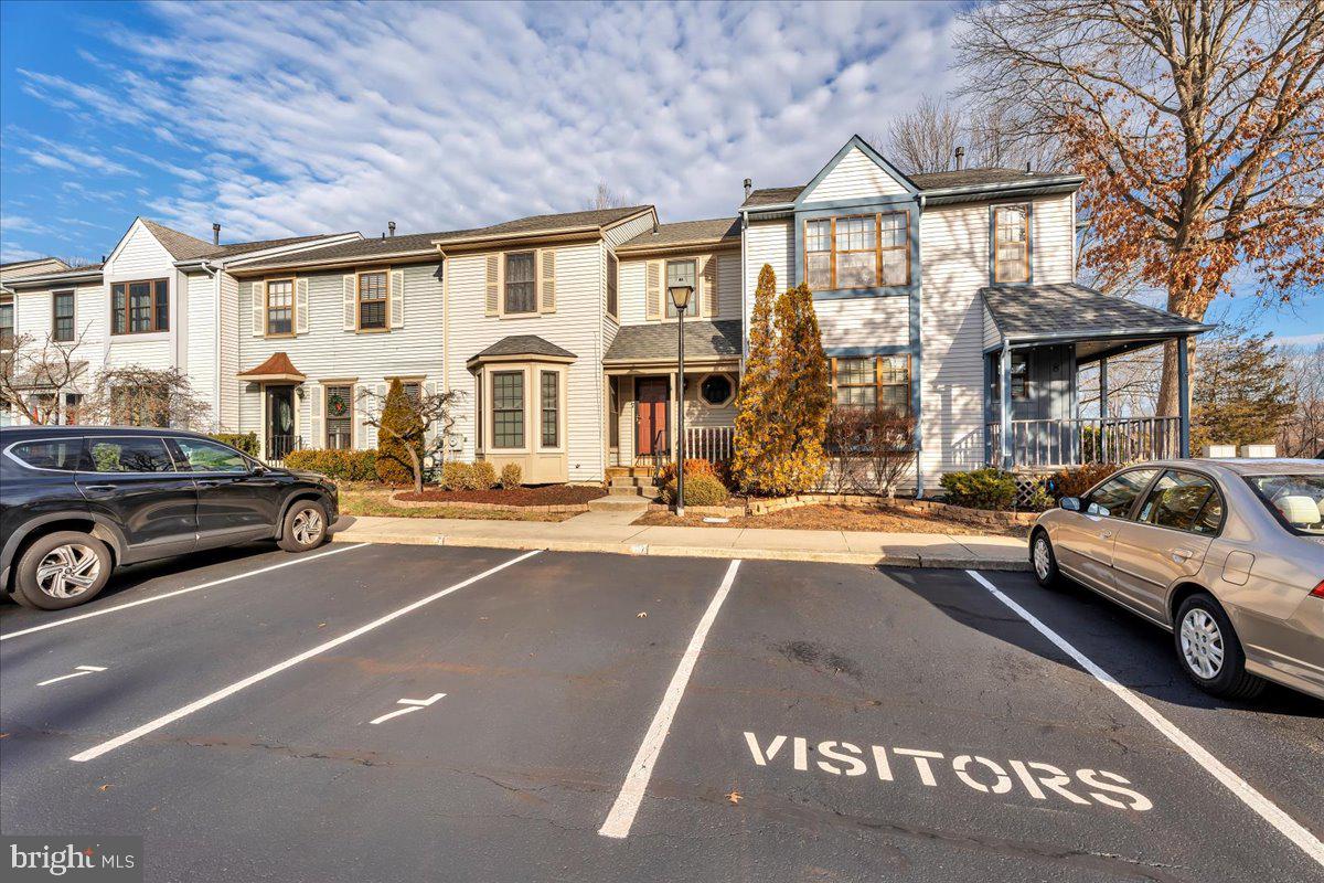 a view of a cars park in front of a building