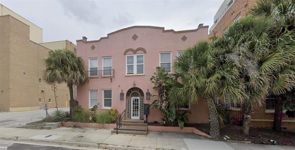 a view of multiple house with palm trees