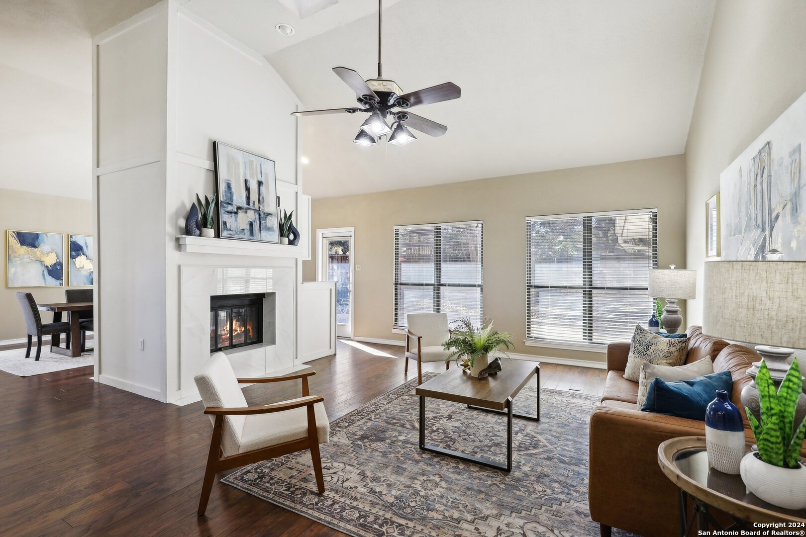 a living room with furniture a chandelier and a fireplace