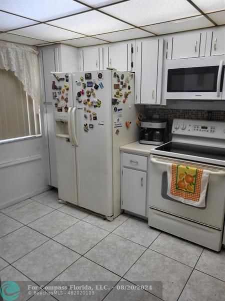 a view of a kitchen with appliances and cabinets