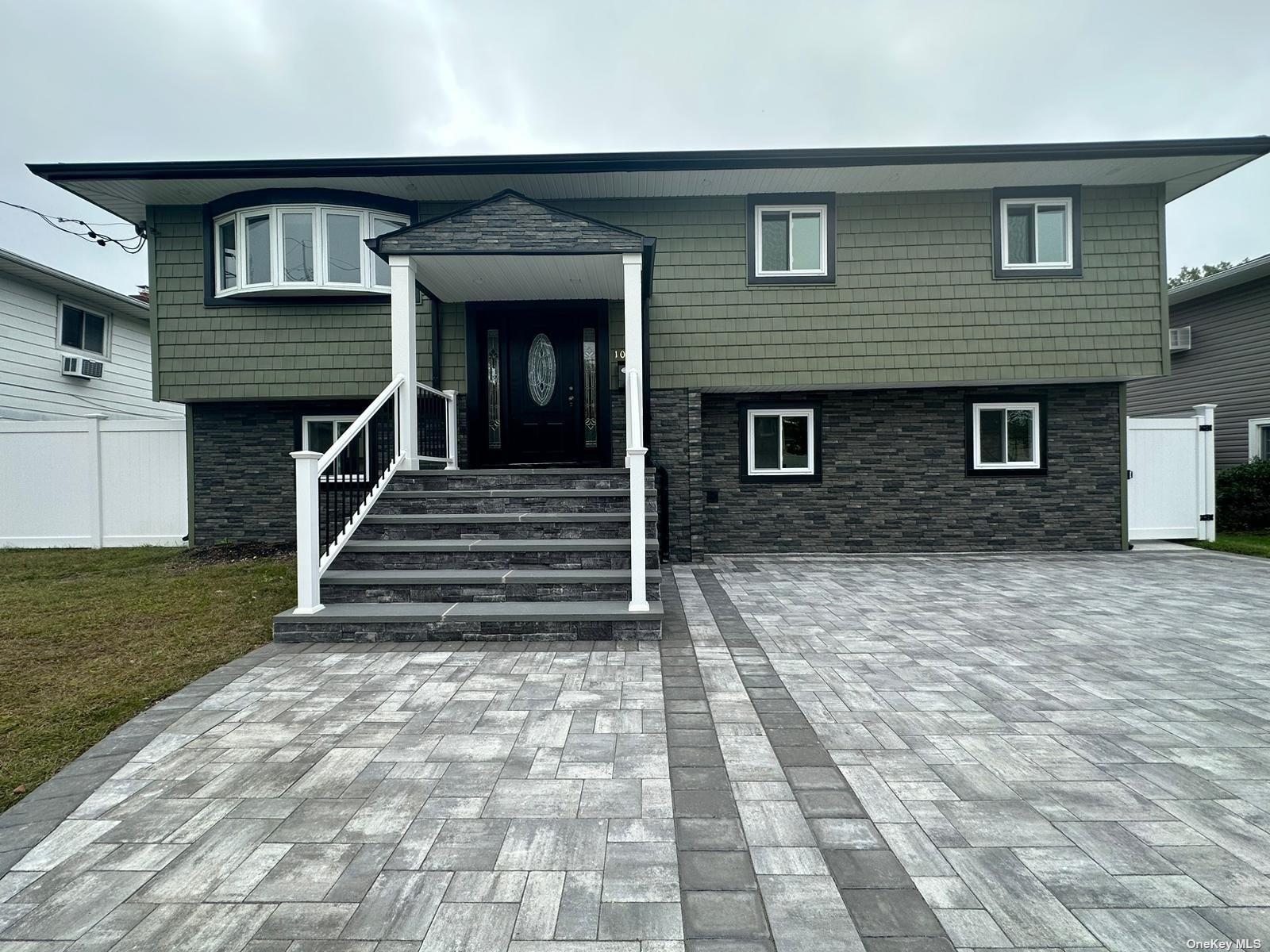 a front view of a house with stairs