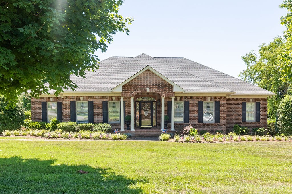 a front view of house with yard and green space