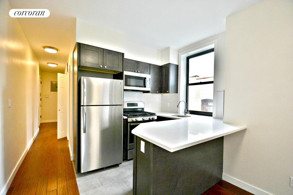 a kitchen with stainless steel appliances a refrigerator and a stove