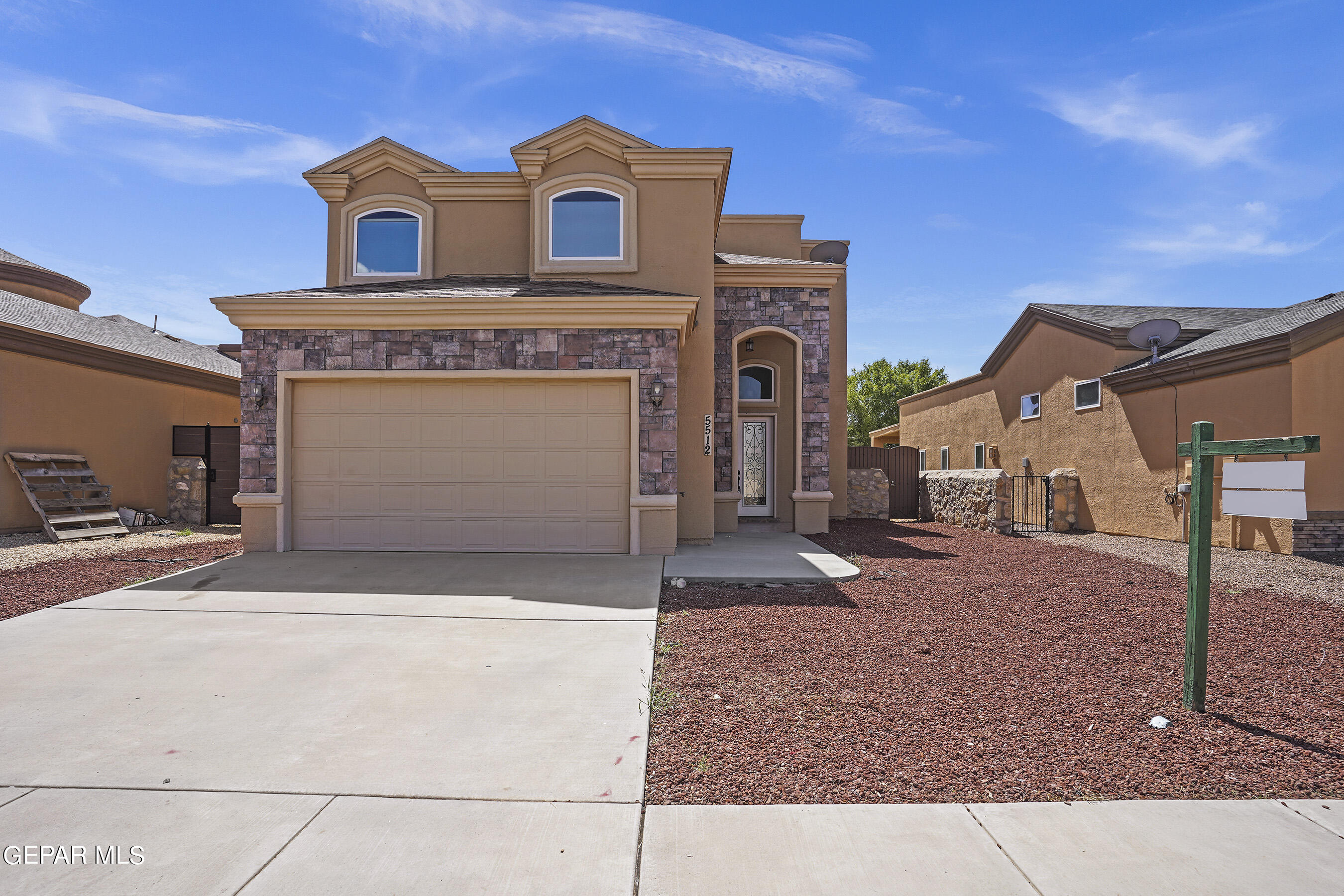 a front view of a house with parking area