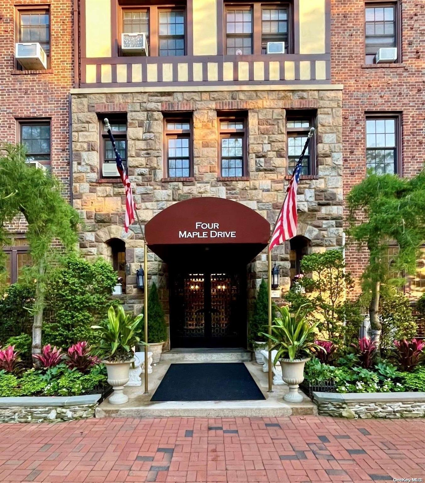 a front view of a multi story building with yard