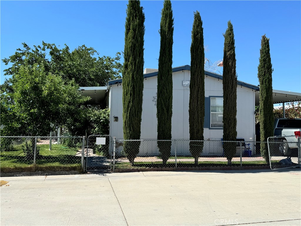 a front view of a building with trees