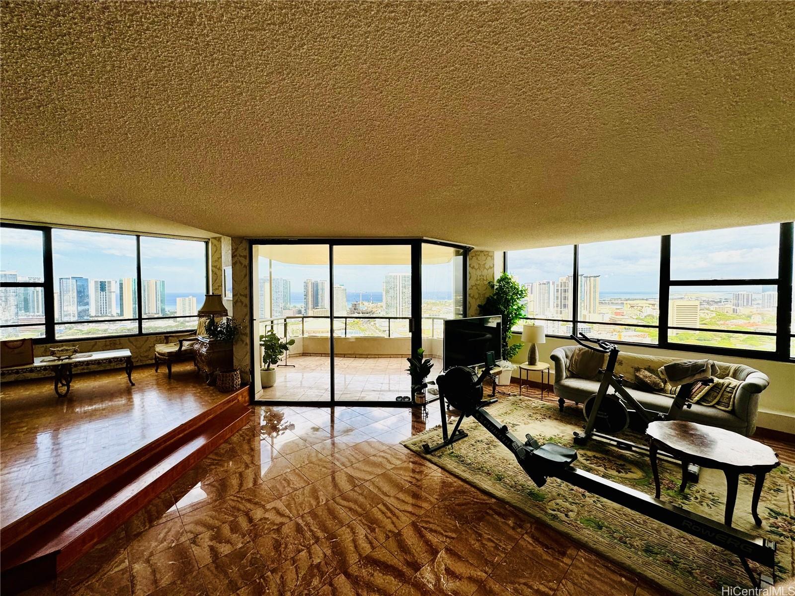 a living room with furniture stove and floor to ceiling window