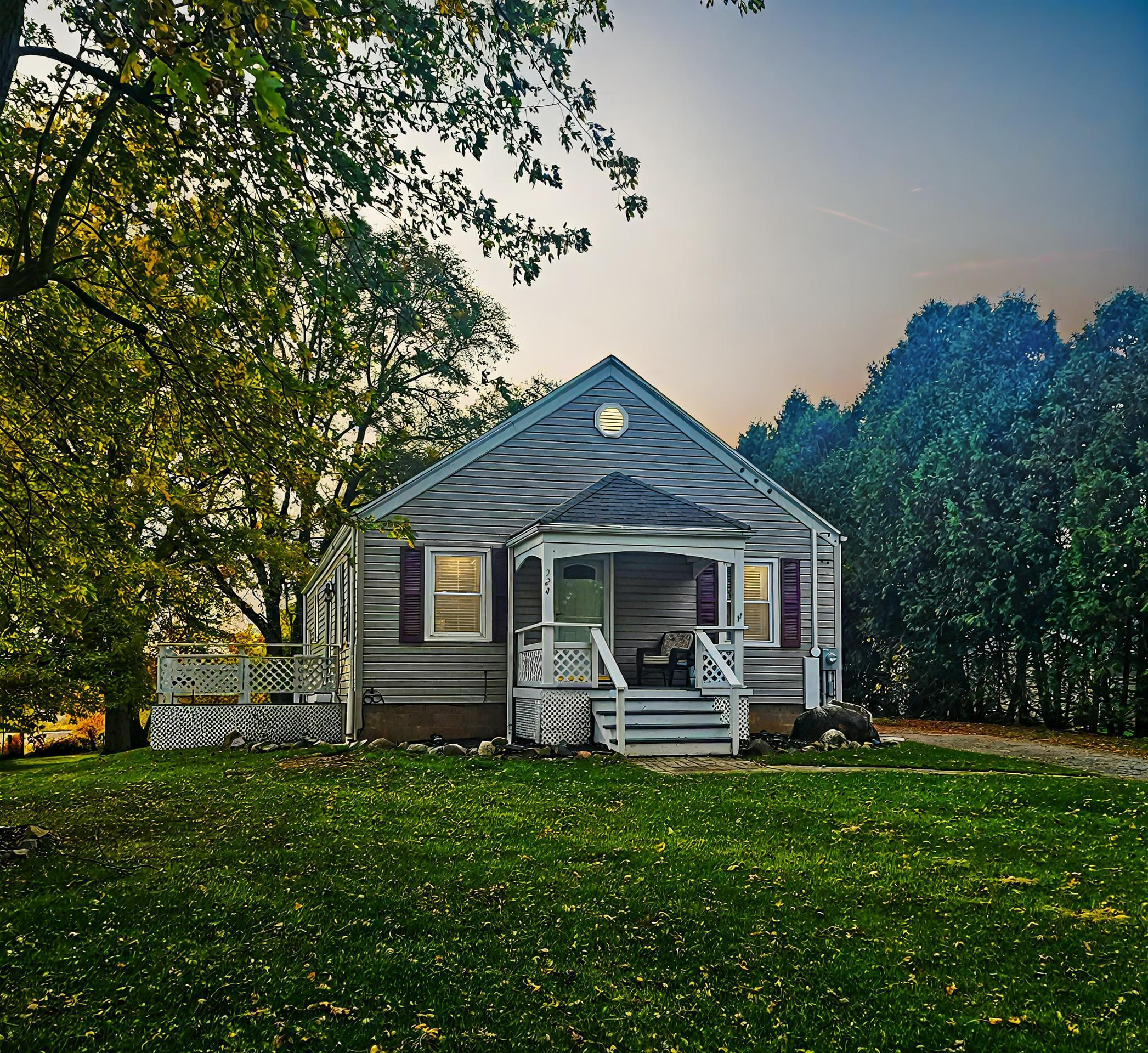 a front view of house with yard and green space