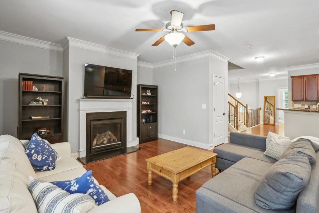 a living room with furniture a flat screen tv and a fireplace