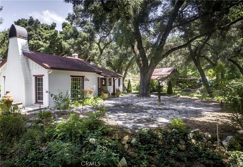 a view of a house with yard and sitting area