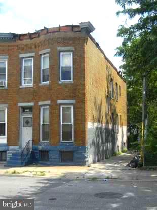 a view of a brick house with a swimming pool