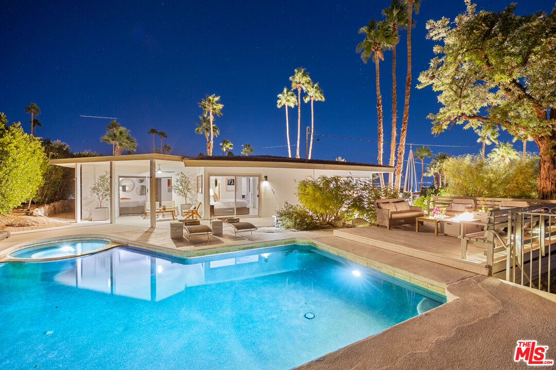 a view of swimming pool with outdoor seating