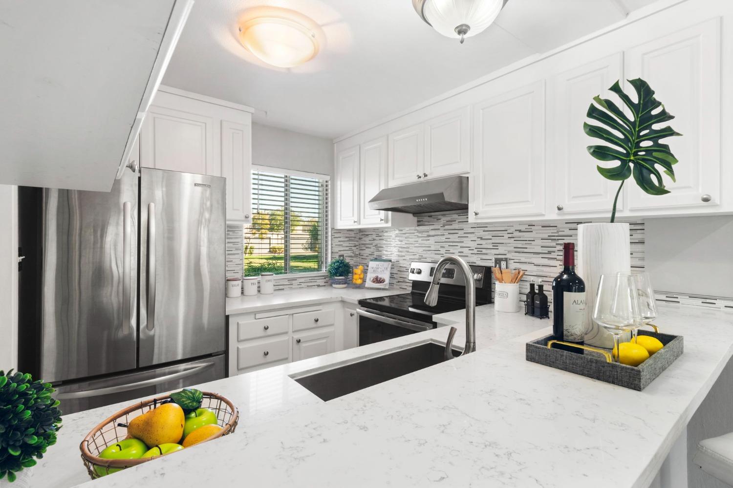 a kitchen with a refrigerator a stove and a sink