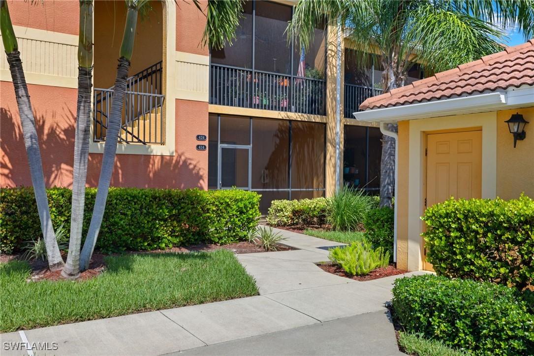 a view of a house with a yard and plants