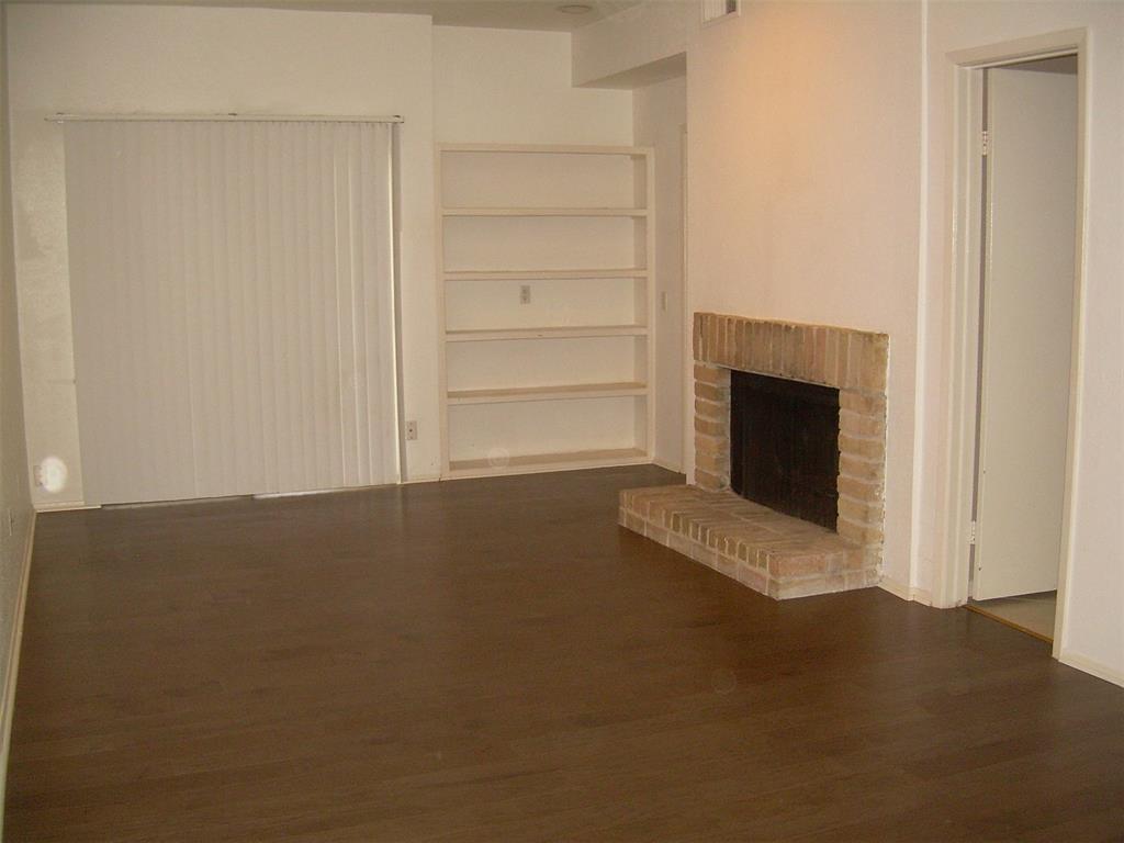 a view of empty room with a fireplace