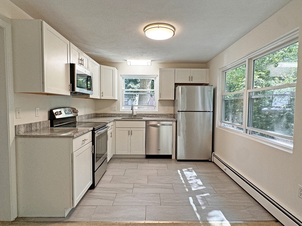 a kitchen with a sink a refrigerator and a stove