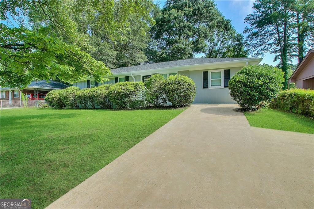 a front view of house with yard and green space