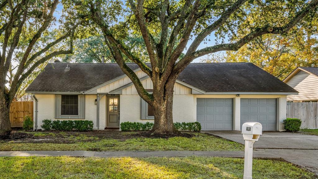 a front view of house with yard and trees