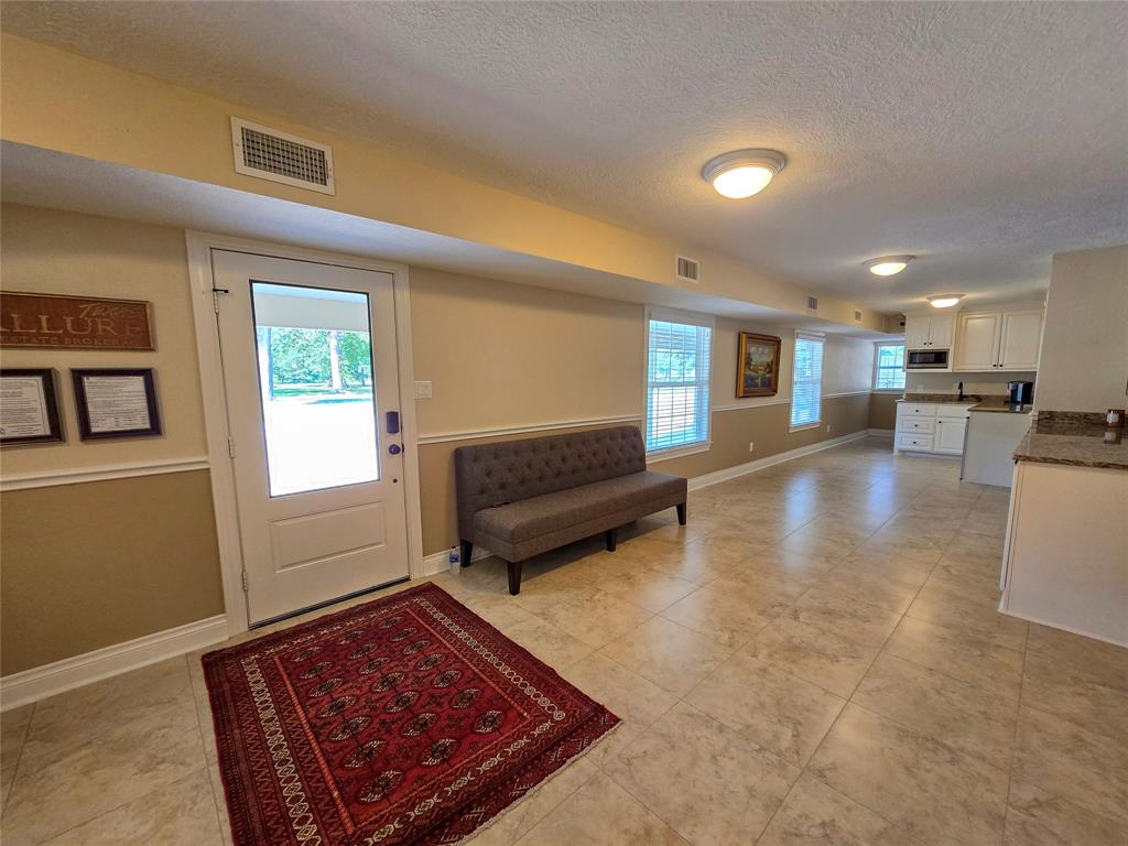 a living room with a couch and a rug