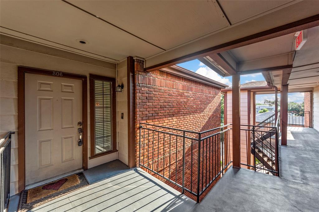 a view of a porch with wooden floor and iron stairs