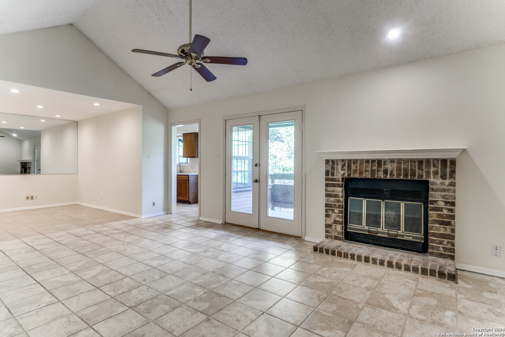 a view of an empty room with a fireplace