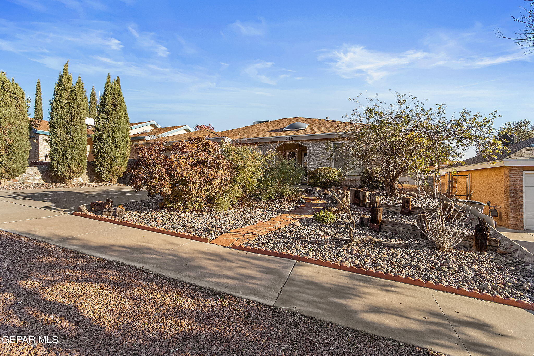 a front view of house with yard and mountain view in back