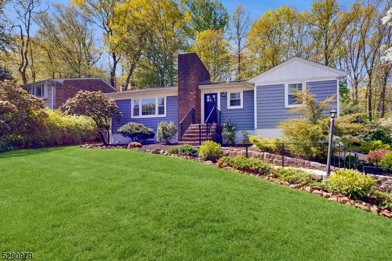 a front view of a house with a garden and plants