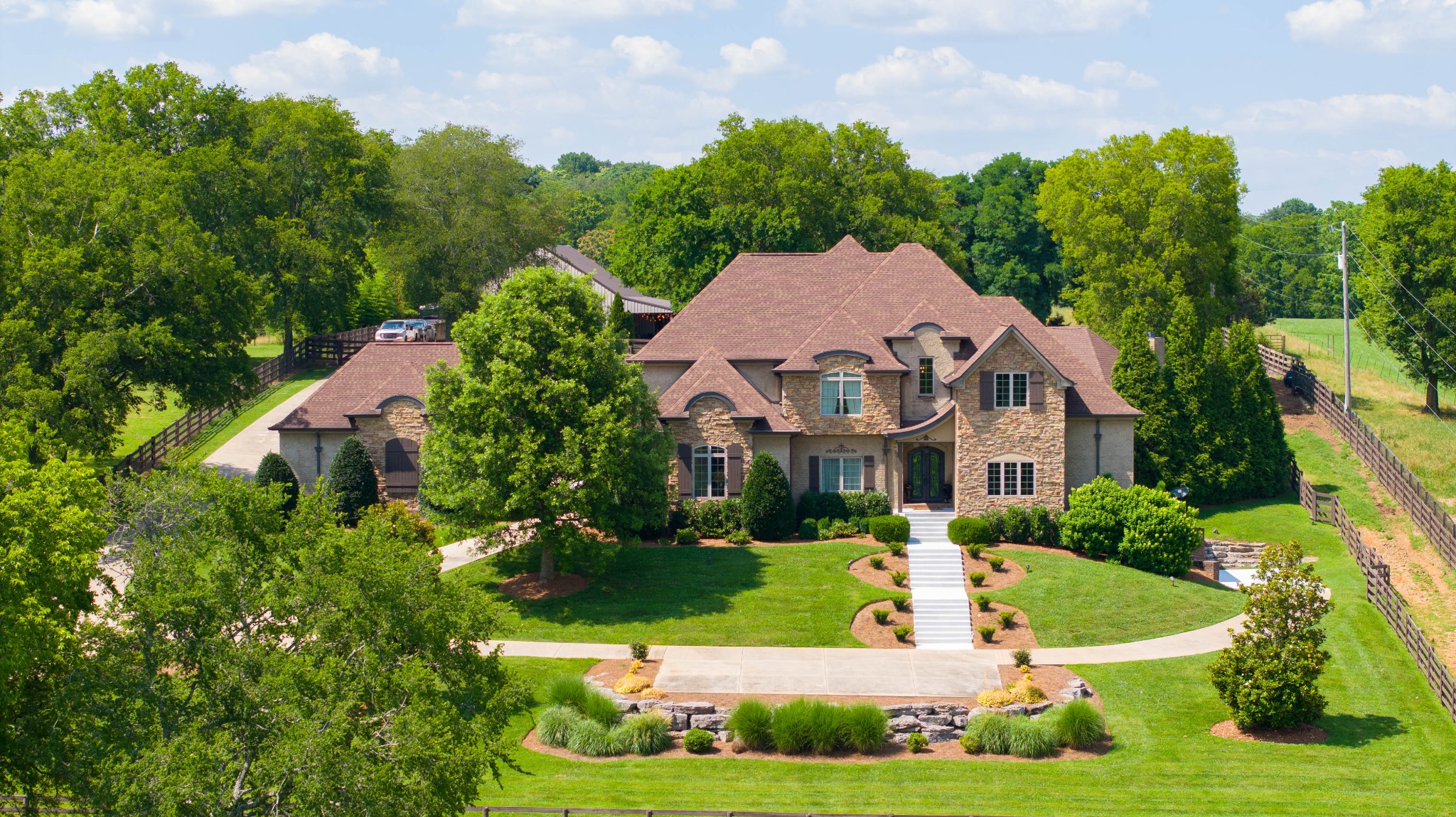 a view of house with garden space and car parked