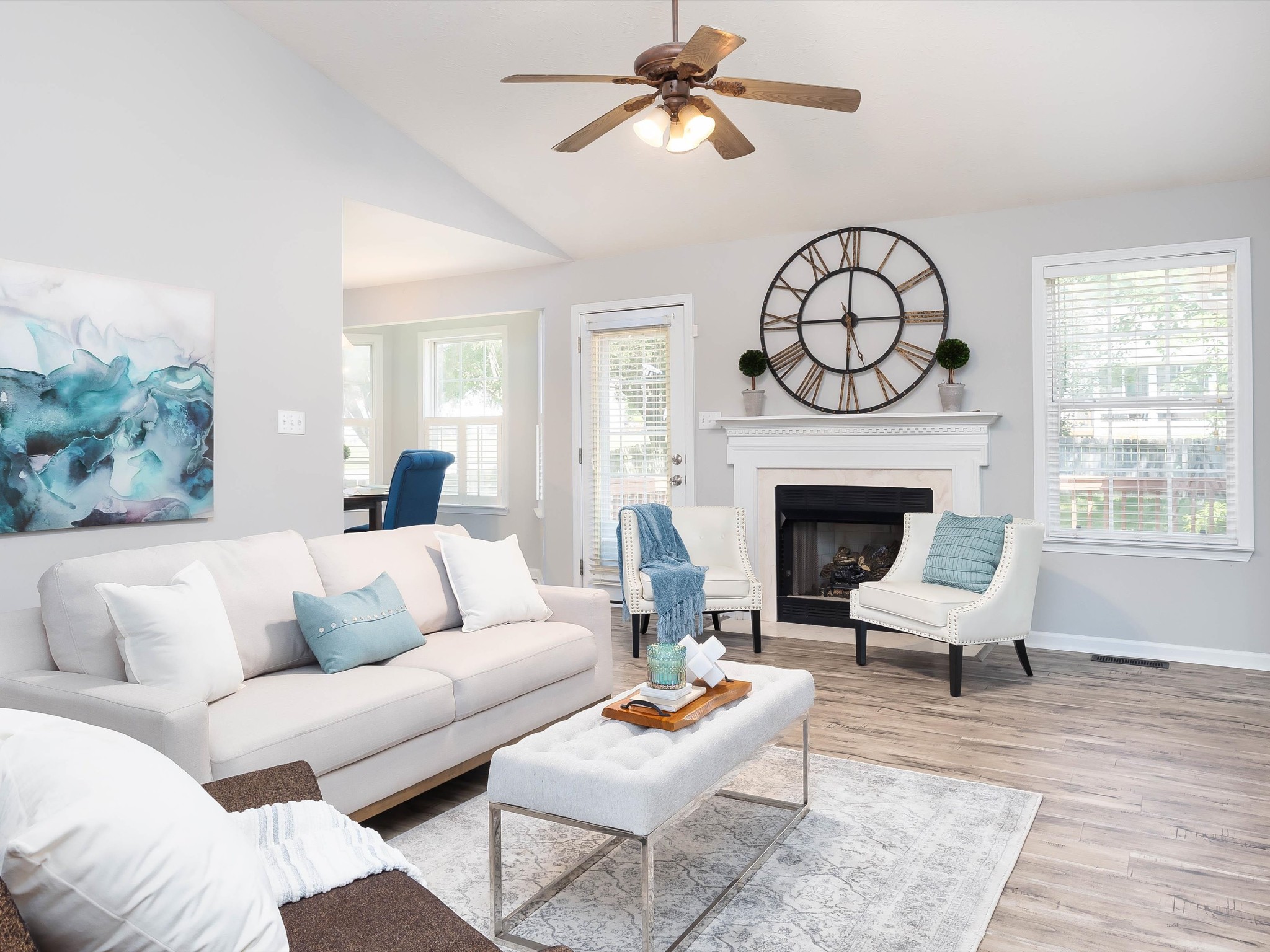 a living room with furniture a fireplace and window