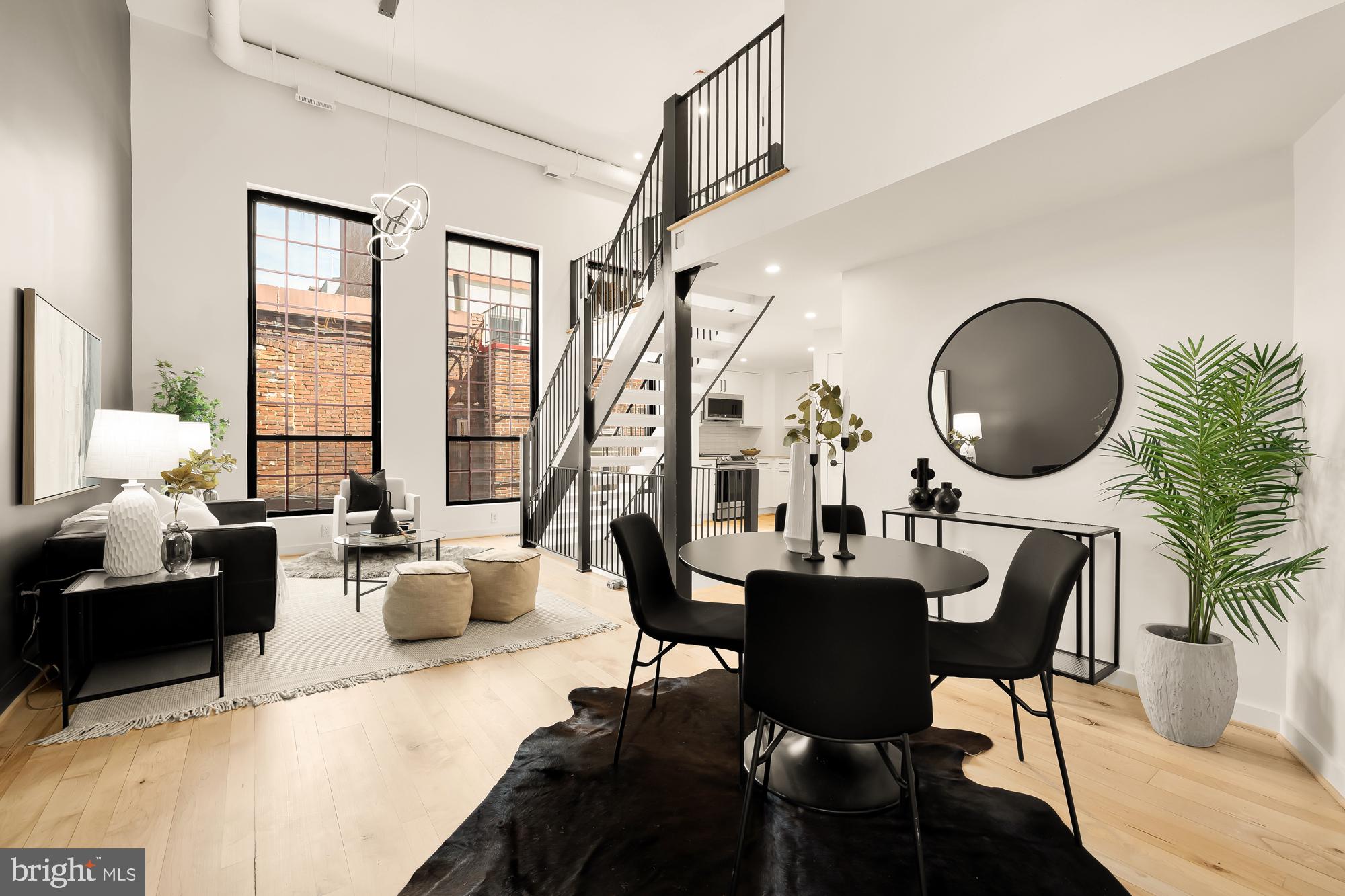 a dining room with furniture a chandelier and wooden floor