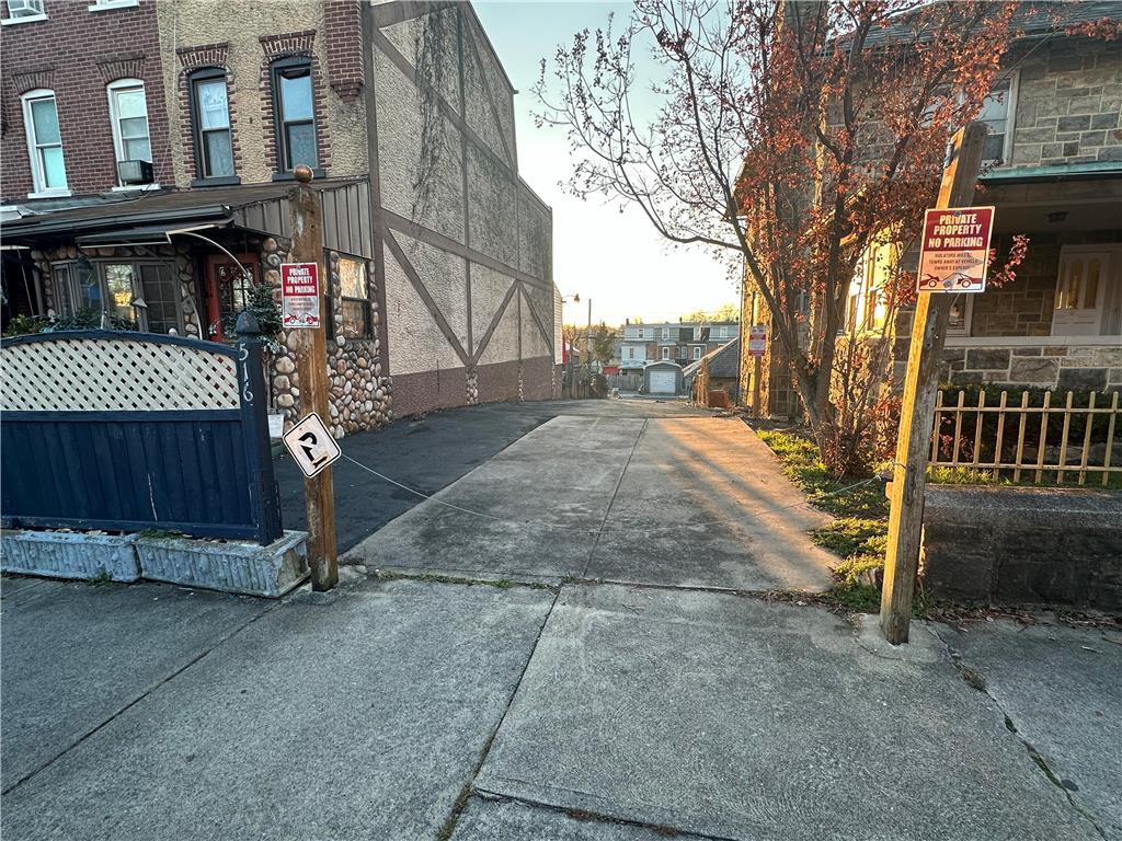 a view of a street with brick walls