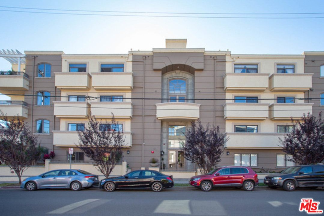 a view of a cars park in front of a building