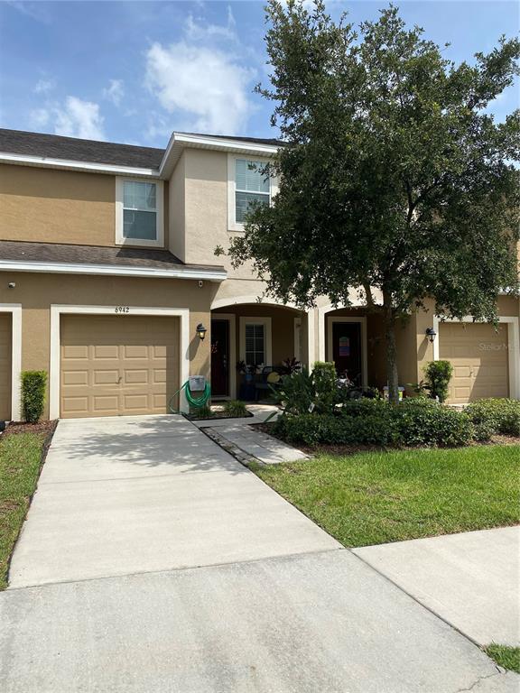 a front view of a house with a yard and a garage