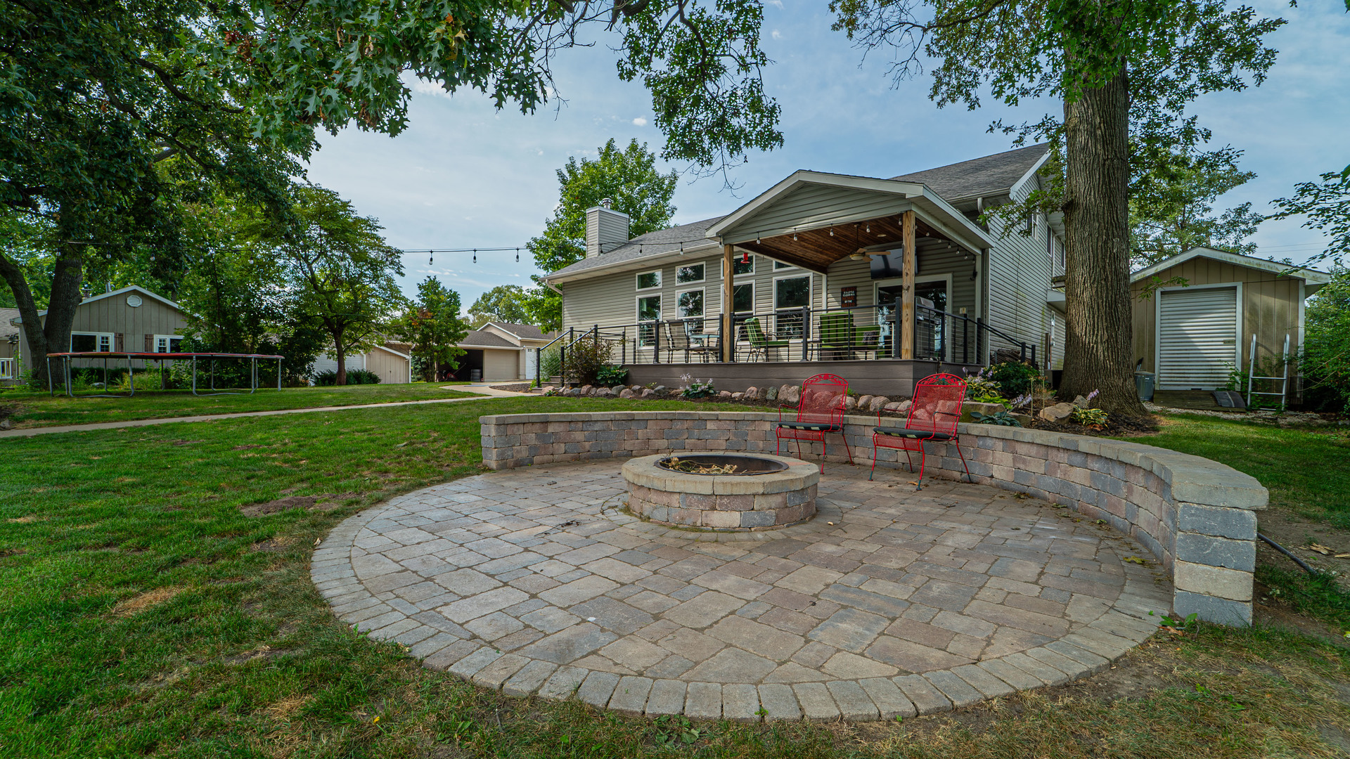 a front view of a house with garden and sitting area