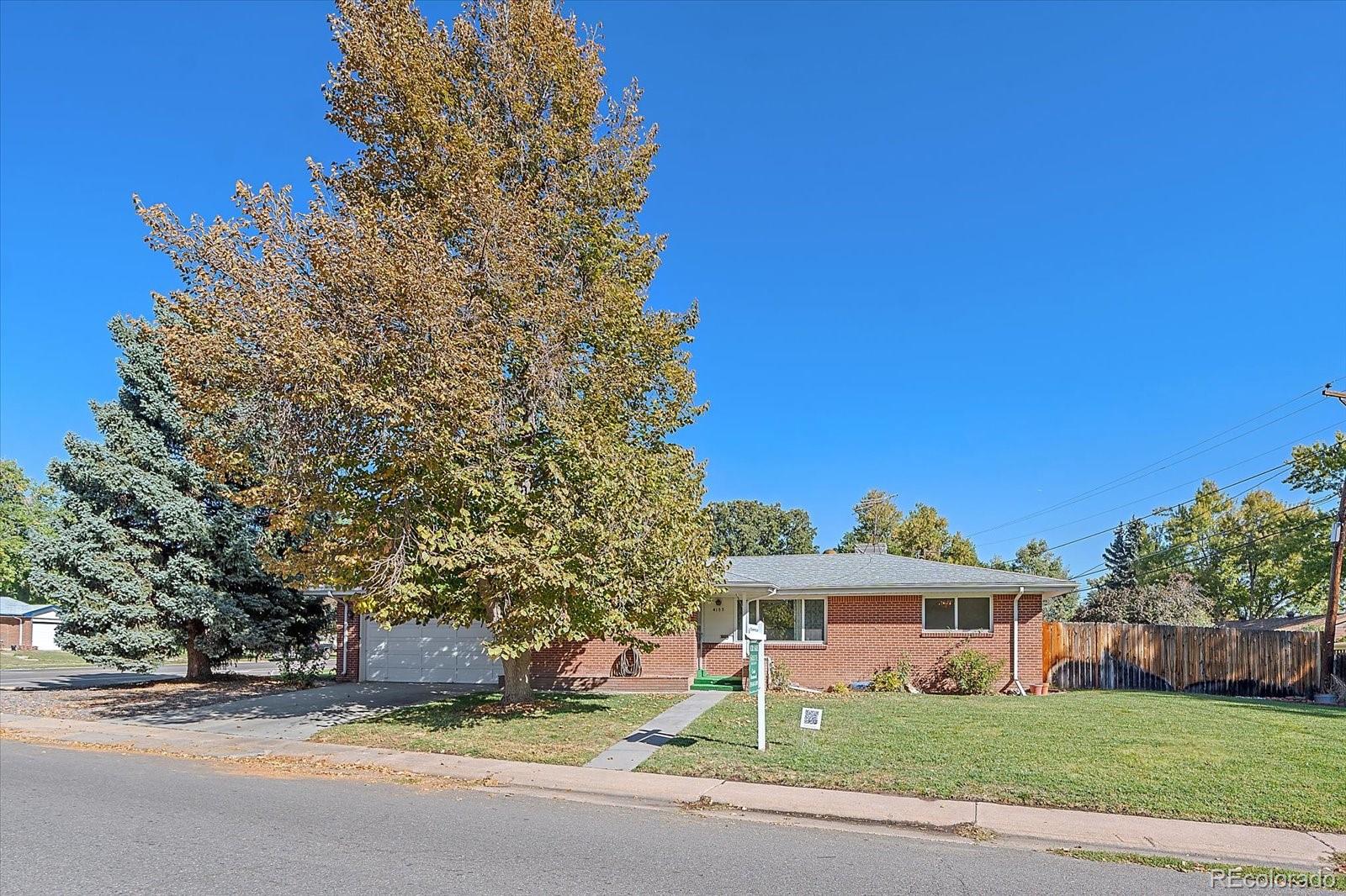 a view of a house with a yard and tree s