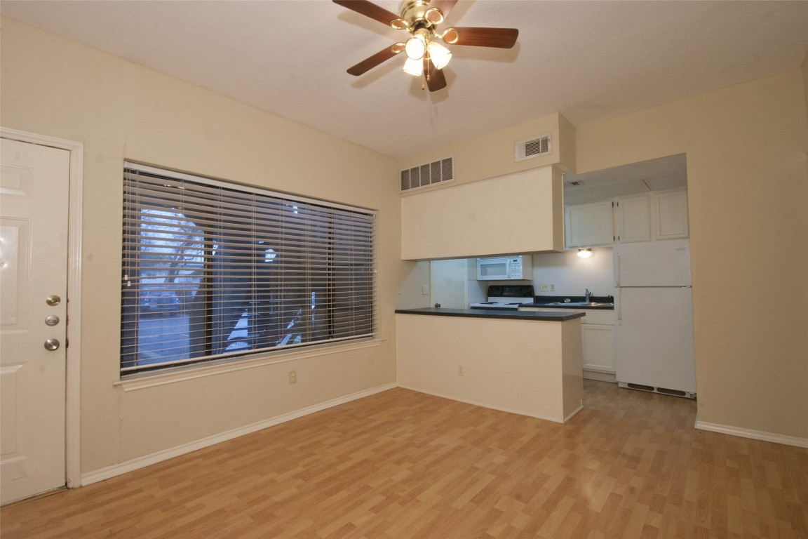 a kitchen with a refrigerator and window