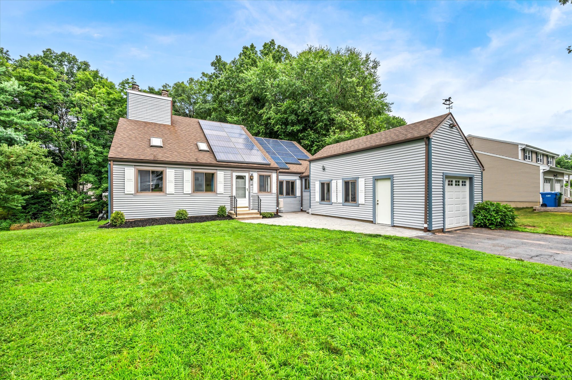 a front view of a house with a garden