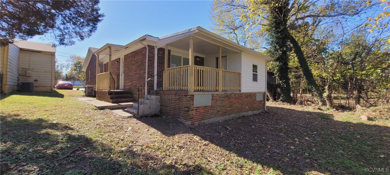 View of property exterior with covered porch, cent