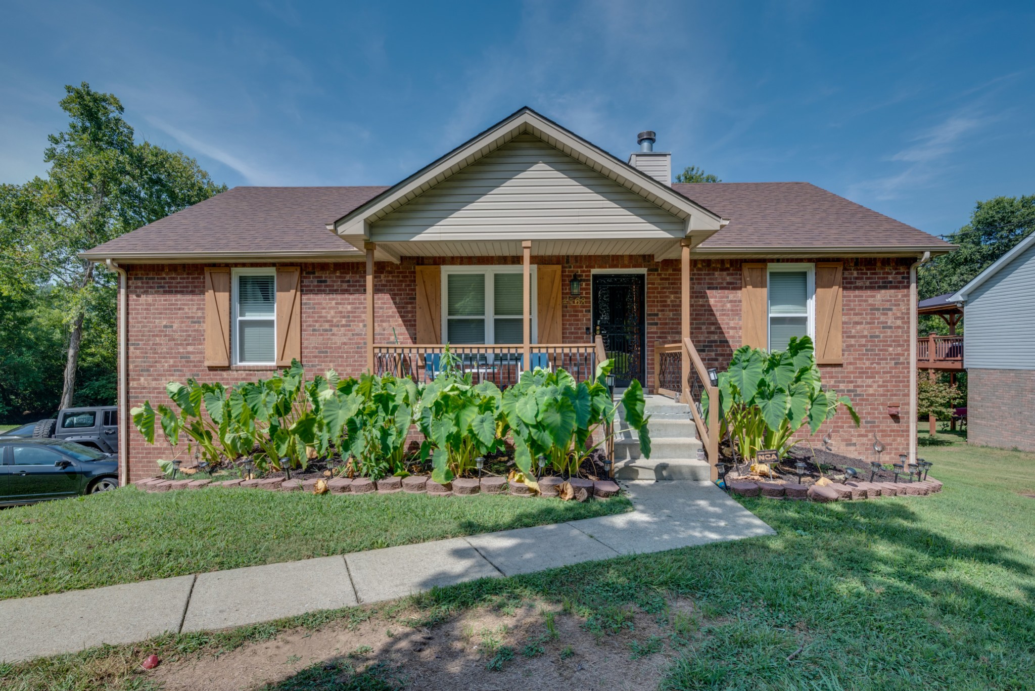 a front view of a house with a garden