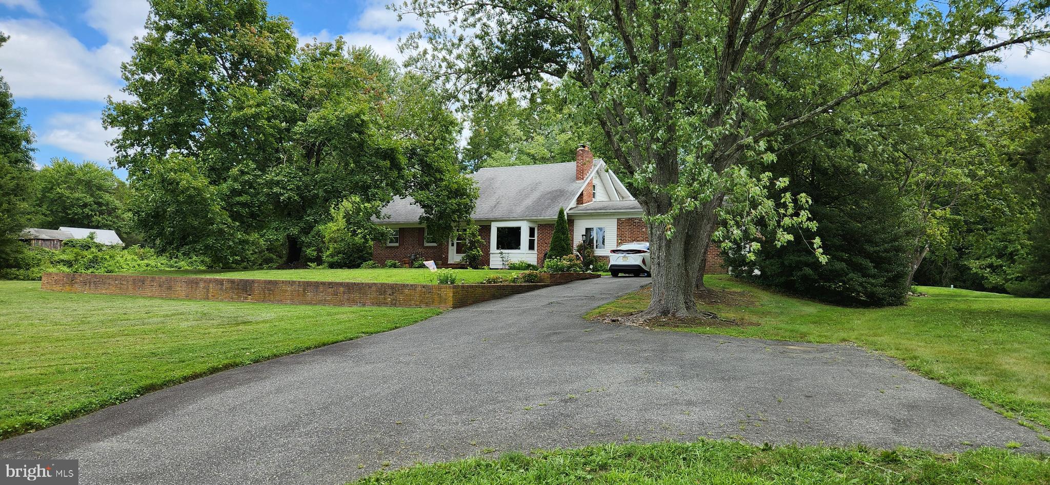 a front view of a house with yard and green space