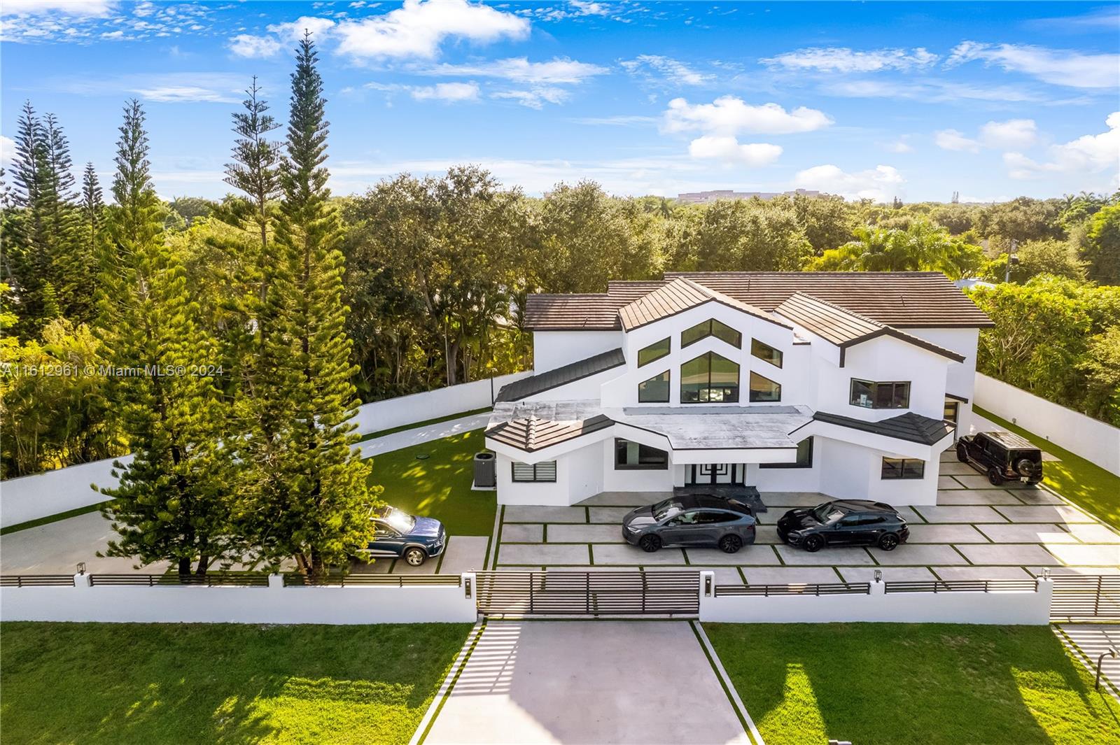 a aerial view of a house with a big yard potted plants and a fountain