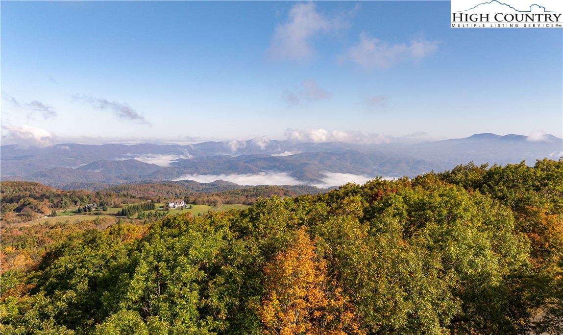 a view of mountain with sunset in background