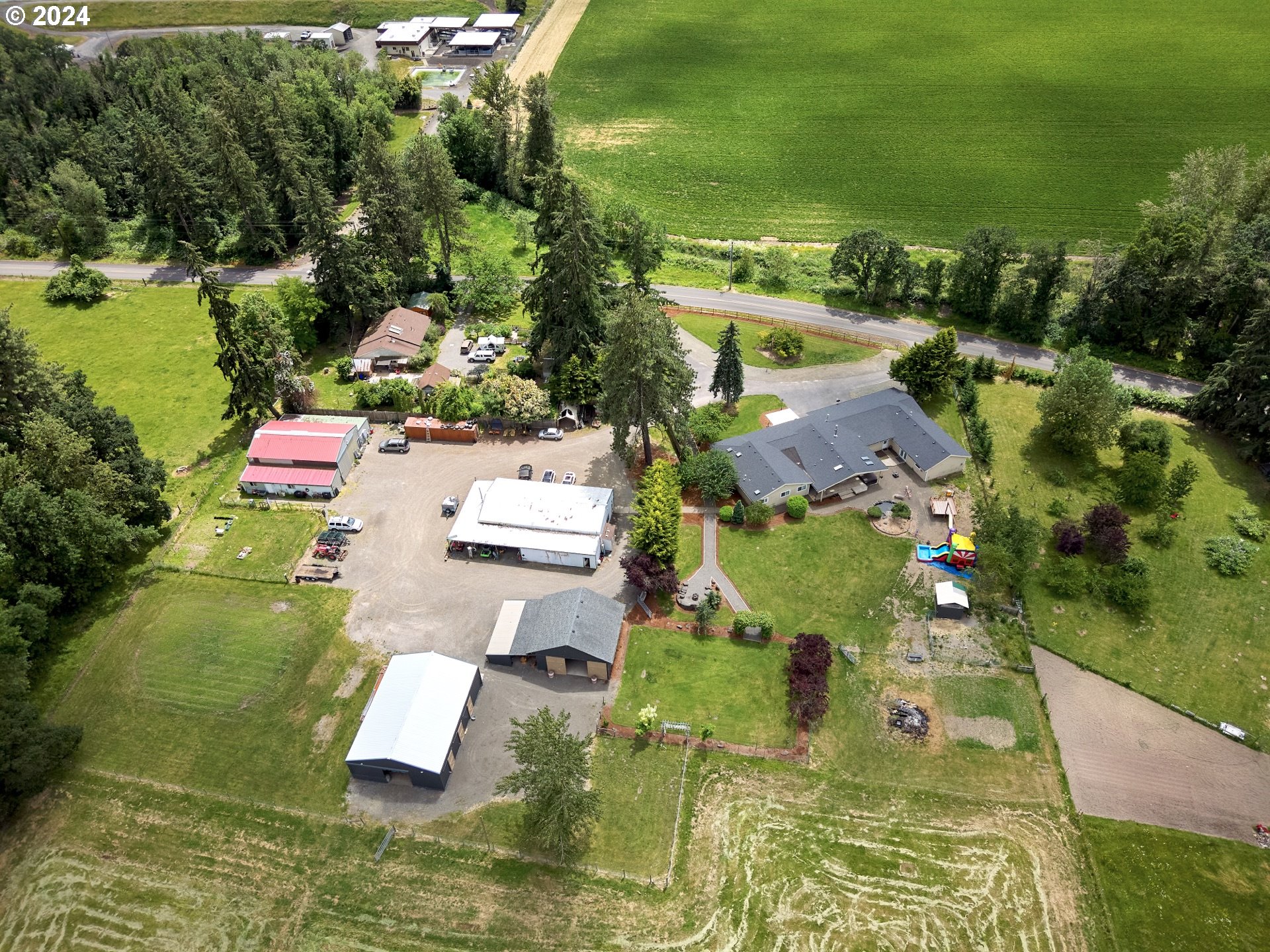 an aerial view of residential houses with outdoor space and swimming pool