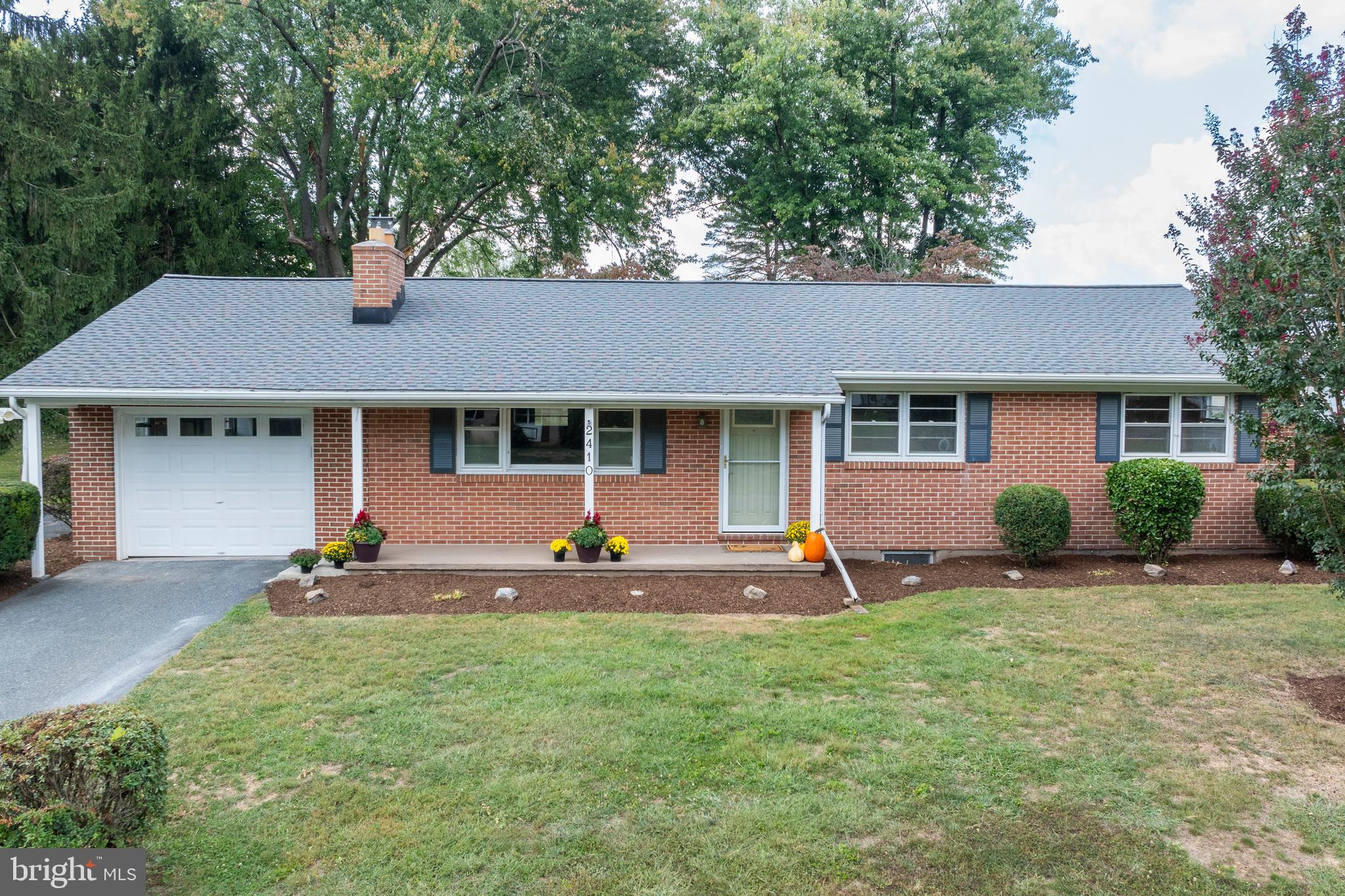 a front view of a house with a garden and porch